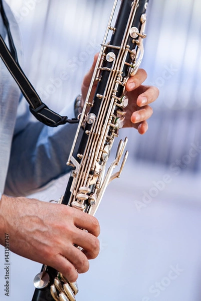 Fototapeta A fragment of a bass clarinet in the hands of a musician