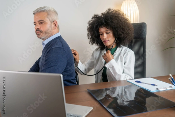 Fototapeta the doctor listens to the patient's lungs and heartbeat	