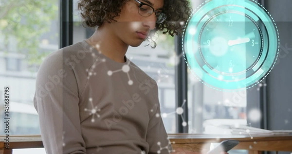 Fototapeta Image of clock moving and shapes over biracial businessman using smartphone