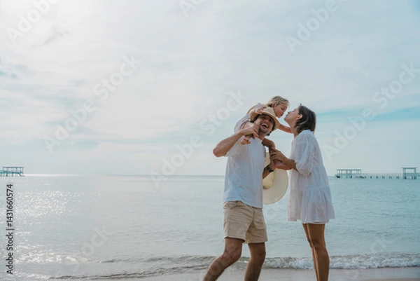 Obraz Happy parents with young children playing airplane running and flying on the beach joyfully, adventurous family on vacation