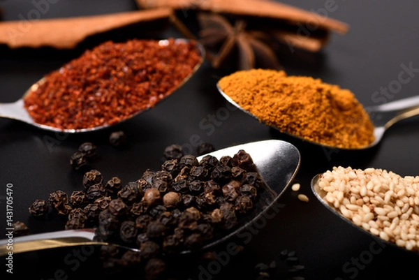 Obraz Close up and soft focus spices, sesame, pepper, turmeric, cayenne peper on black background.