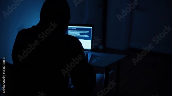 Obraz Hacker hacks programs. Computer scammer. Programmers working intently on laptop, typing in dark room with shadowy atmosphere, evoking cybersecurity intensity and digital intrigue
