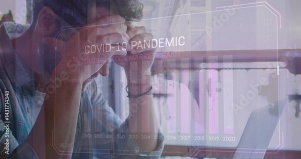 Fototapeta Image of covid 19 data processing and statistics over worried caucasian man using laptop