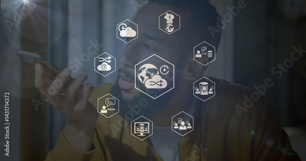 Fototapeta Image of connections with technology icons over biracial man using smartphone