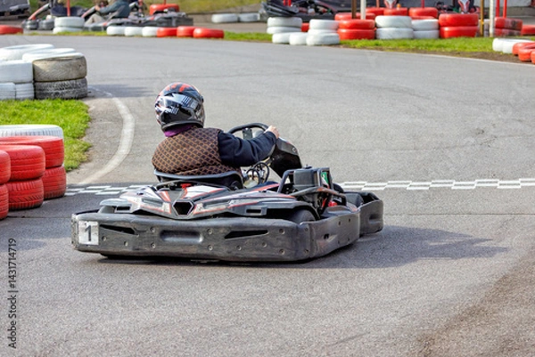 Fototapeta Exciting go-karting adventure on a thrilling racing track during bright afternoon