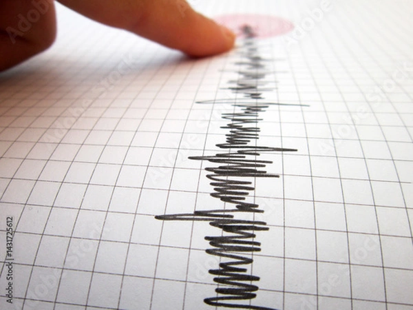 Fototapeta     Seismograph and earthquake. A hand pointing at a seismograph recording the seismic activity of an earthquake                           