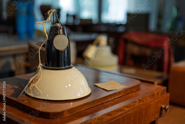 Fototapeta A lamp is sitting on a wooden table