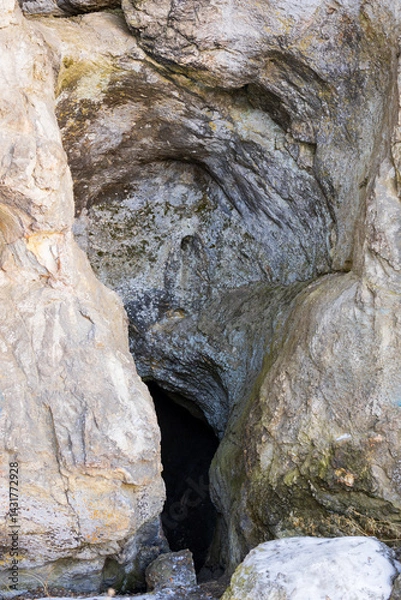Fototapeta a cave in a rock, an old rock with a hole in it