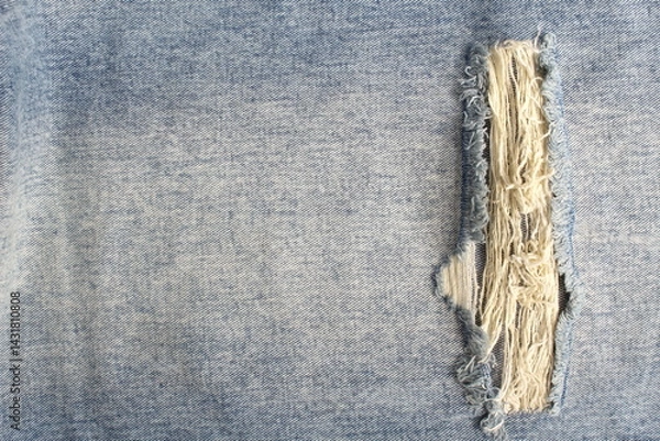 Fototapeta Denim background with torn pattern.