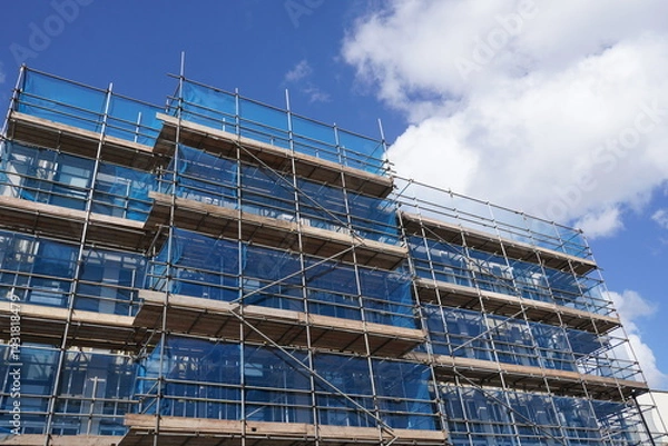 Fototapeta building under construction with scaffolding. construction industry