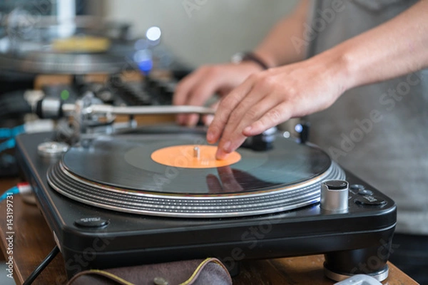 Obraz Dj play music at hip hop party.Turntable vinyl record player,analog sound technology for disc jockey to scratch vinyl records and mix tracks