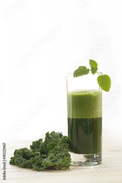 Obraz Green vegetable juice in a tall glass with a leaf of kale and mint