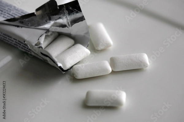 Obraz Chewing gum and wrapping foil; selective focus.