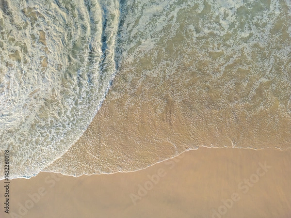 Obraz Aerial view of big waves lapping the sandy beach