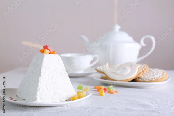 Fototapeta Traditional curd Easter cake with candied fruits on light table
