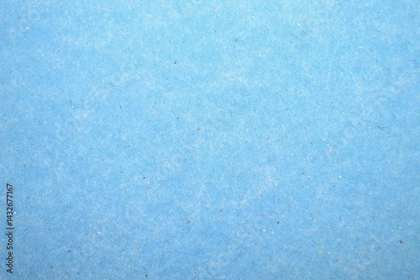 Fototapeta A delicate close-up of a textured blue surface of paper folder, revealing a serene interplay of smooth gradients and intricate patterns for a calming visual effect