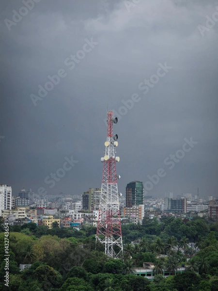 Obraz Communication signal tower in dark cloudy storm nature in rainy season. Mobile network tower in Dhaka in the middle of the city standing in stormy cloud weather. Strong network anytime concept.