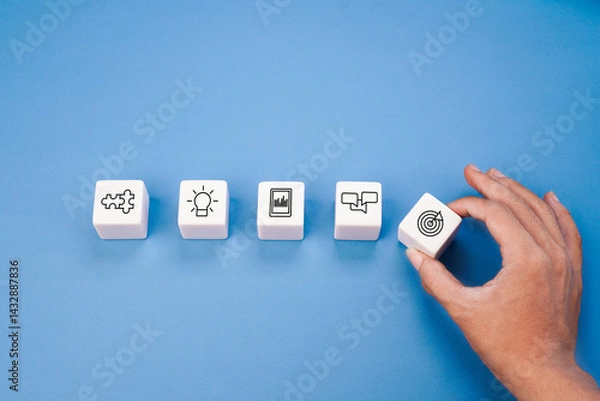 Fototapeta White blocks with business ideology concept icon hold by hand