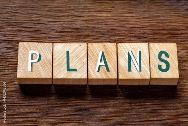 Fototapeta Wooden Blocks Spelling Plans Arrangement on Wooden Surface for Visual Concept of Planning Strategy and Organization