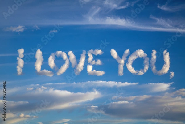 Fototapeta Heartfelt Message in the Sky: 'I Love You' Formed by Soft Clouds Against a Clear Blue Background