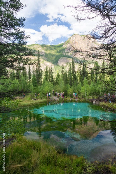 Obraz Altai republic, Russia - 26 July 2020: Tourists at Geyser blue lake in which fountains at the bottom color blue circles in the vicinity of the village Aktash, Altai Mountains