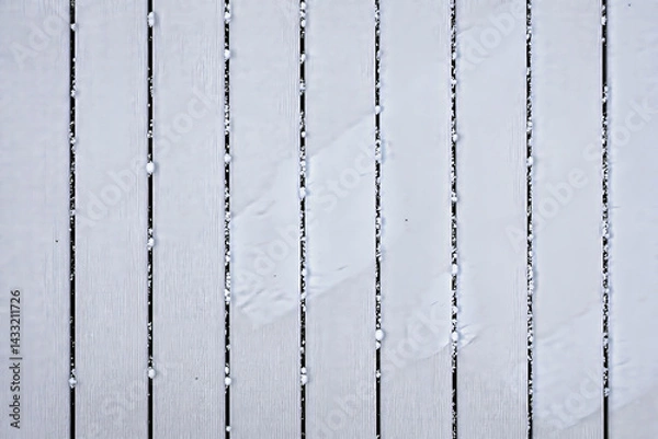 Fototapeta close-up view of a snow-covered surface with vertical lines creating a textured