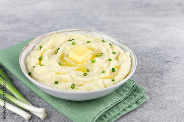 Obraz Mashed potatoes with melted butter and chopped green onions on a gray background. Irish mashed potatoes champ.