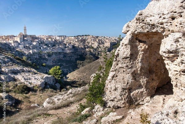 Obraz Cave on cliff with cliffs with buildings on the Gravina di Matera of Matera, Italy, know for the Sassi or Ancient town with its rock-cut urban core and twin cliffside zones, collectively the Sassi