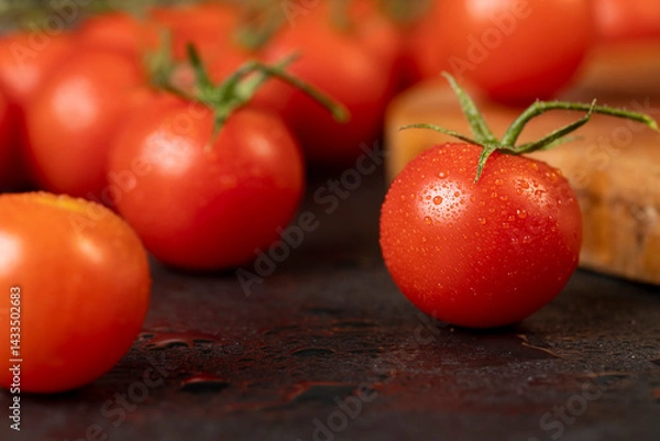 Fototapeta several red cherry tomatoes on the table with small green tails