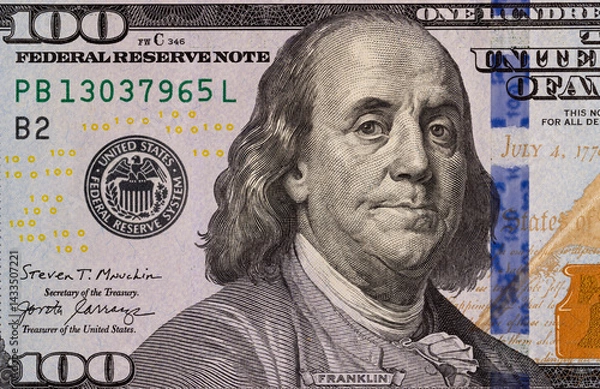 Fototapeta part of a paper bill of American dollars with a pattern close up, top view