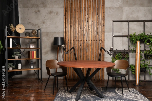 Obraz Creative podcast studio featuring a circular table and dual microphones set up for an engaging interview session