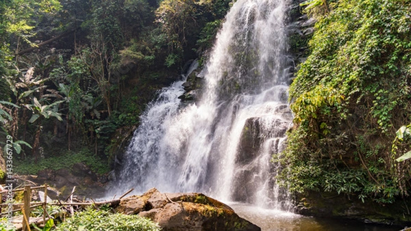 Fototapeta Tropical waterfall cascading through the jungle