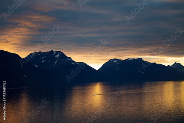 Obraz A picturesque sunset over the mountains creates stunning reflections in the calm waters