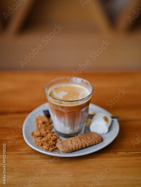 Fototapeta Coffee. A morning drink : dirty coffee served with burned marshmallow and biscuit on wooden table with copy space for your text.