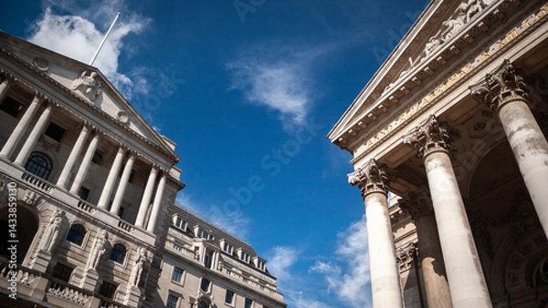 Fototapeta British Financial Institutions. A low, wide-angle view to the facade to the iconic Bank of England building and Royal Exchange in the heart of The City of London's financial district.