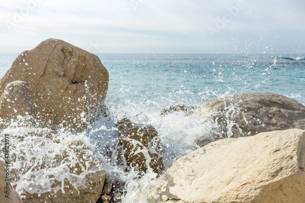 Fototapeta rocky beach in Cyprus and splashing waves