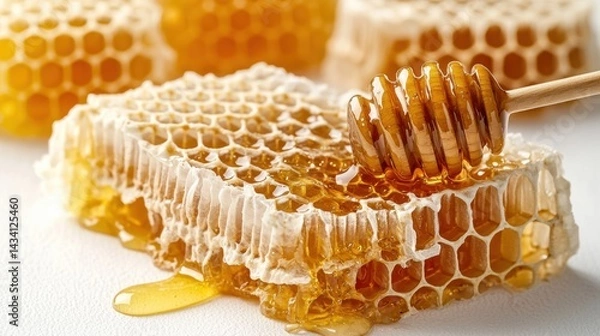 Obraz Close-up of fresh honeycomb with golden honey dripping off, detailed texture highlighting hexagonal beeswax cells and natural sweet nectar for food or nature themes