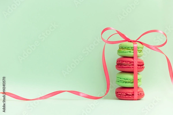 Obraz Macaroons or macaroni tied by ribbon on retro style pop art background. Free space for text
