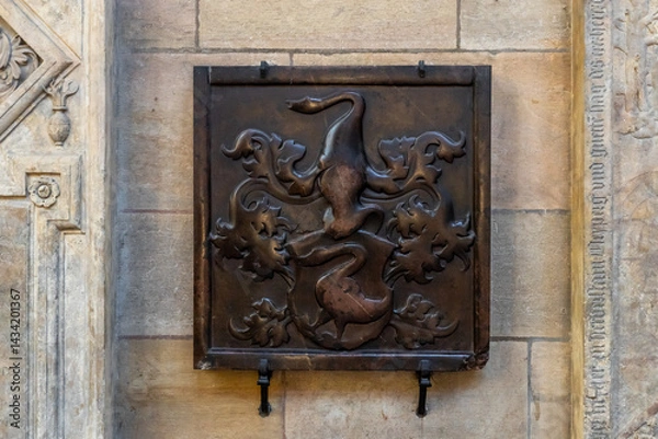 Fototapeta Decorative tombstone in the wall of St Vitus Cathedral facade in historical part of Prague in Czech Republic