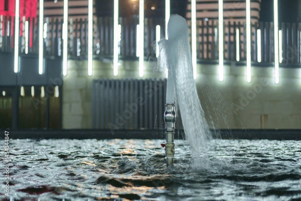 Fototapeta Still water of fountain splashing in air at night