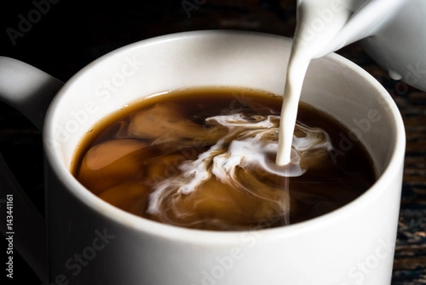 Fototapeta Pouring Cream into a Cup of Coffee
