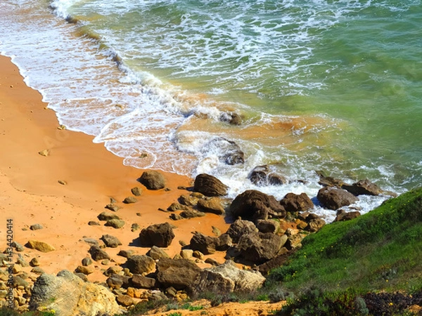Fototapeta Sea surf at a typical Algarve beach with cliffs rocks and red sand
