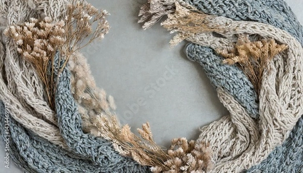 Fototapeta A boho background with knitted scarf, dried flowers, and copyspace 