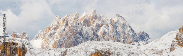 Fototapeta View of the Dolomites, Italy. Mountain landscapes with snow and ice. Sharp rocks as a background. Place for mountain hiking, traveling and vacation. Wallpaper, postcard, photo.