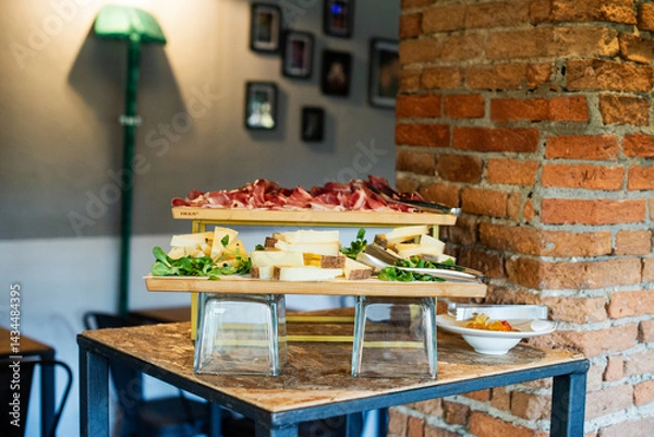Fototapeta Delicious charcuterie and cheese spread on display