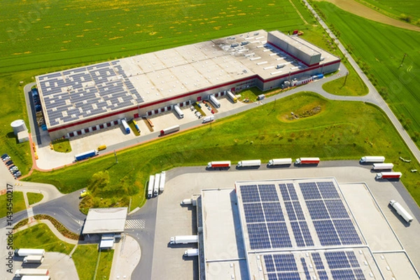 Fototapeta Industry with low carbon footprint. Industrial warehouses with solar panels on the roof. Technology park and factories from above