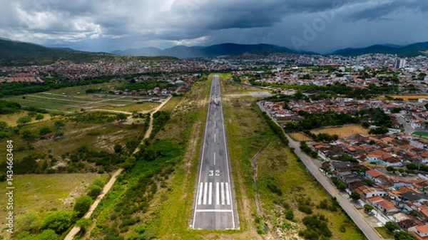 Obraz Short of the landing strip 32 in small airport, aerial view with mountains