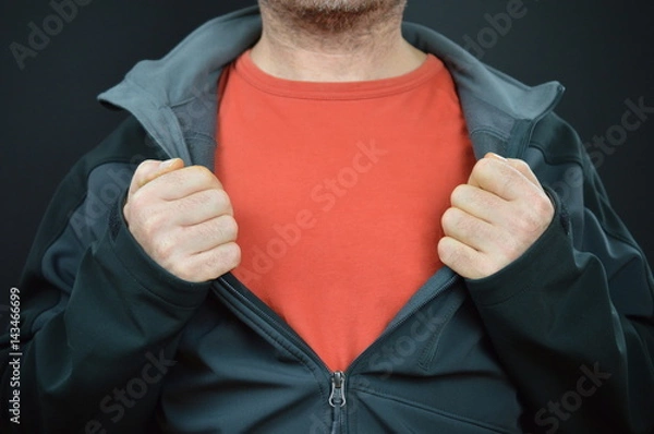 Fototapeta man showing his red t-shirt under a black jacket with empty space for a message 
