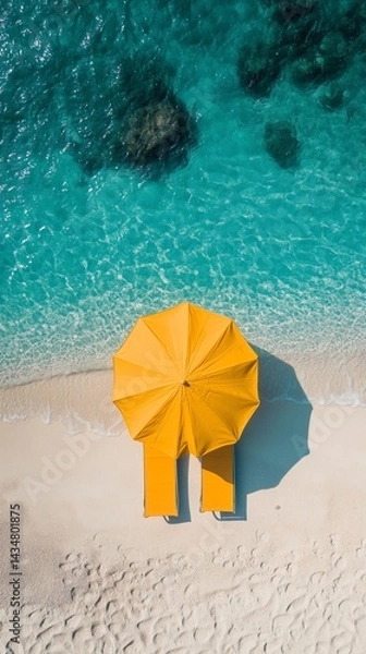 Obraz Drone view of yellow umbrella and sunbed on empty beach with turquoise water gradient, vertical format