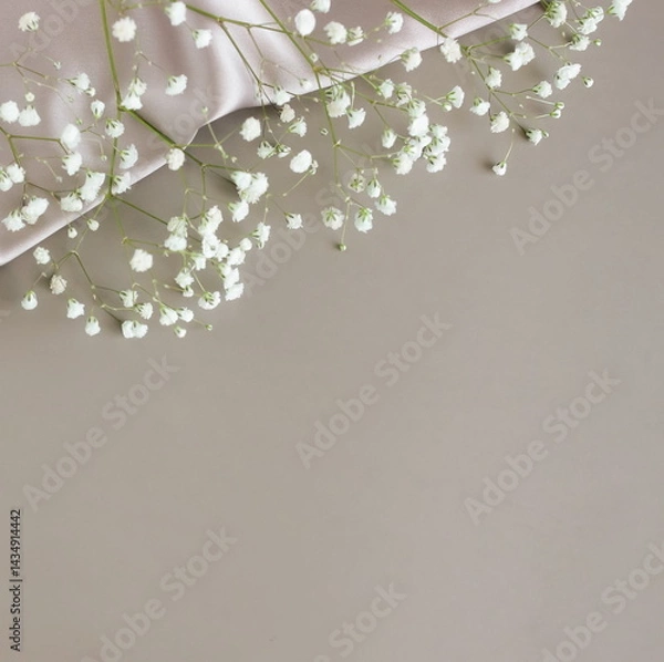 Fototapeta Holiday template background with white flowers frame on grey silk and paper texture background with copy space.Top view. Empty blank, greeting card mock up, floral template, Mother's day backdrop. 
